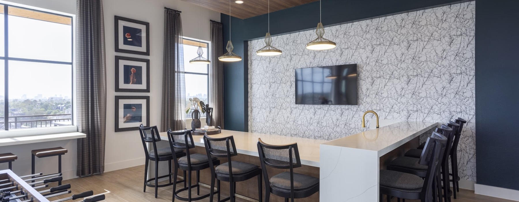 lounge area with a large table and bar-style seating
