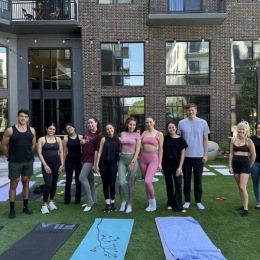 a group outdoors in yoga outfits