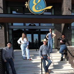 a group standing outside of the property