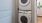 stacked laundry machines in a closet