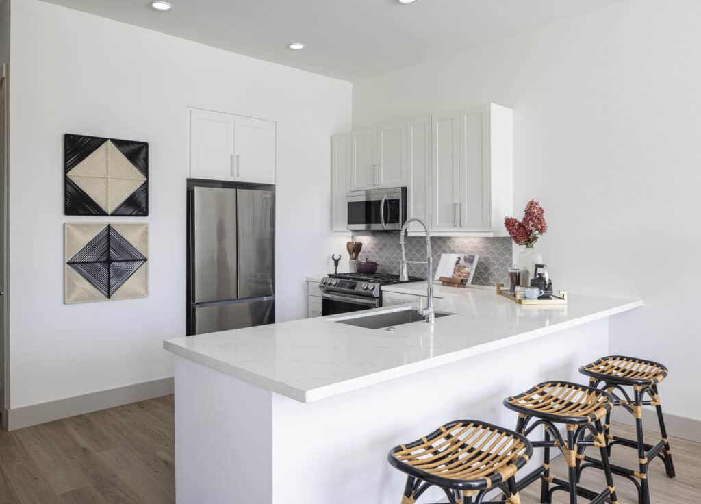 Kitchen with white cabinets and counters at Broadstone Emeline Heights in Houston, TX